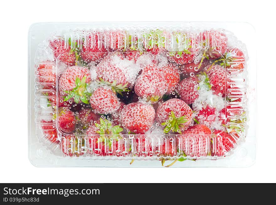 Frozen strawberries in closed box isolated on white