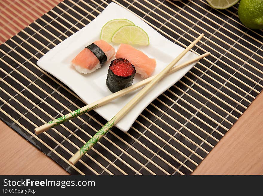 Japanese sushi with chopsticks on bamboo mat