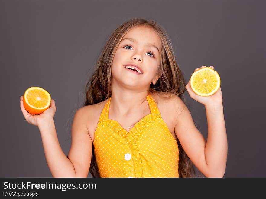 Cute young girl with oranges