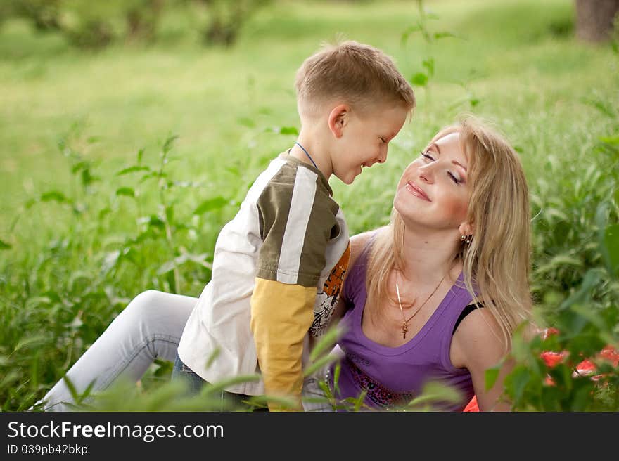 Happy Mother and Son in green garden