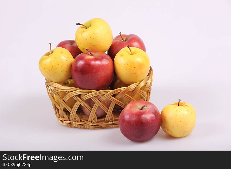 Colored red and yellow apples in basket