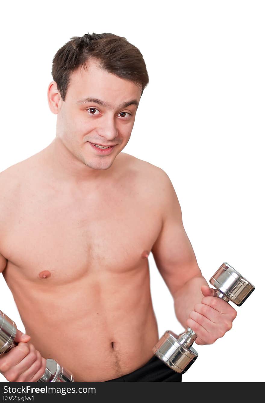 Young man with naked torso with dumbbells in sport club on white