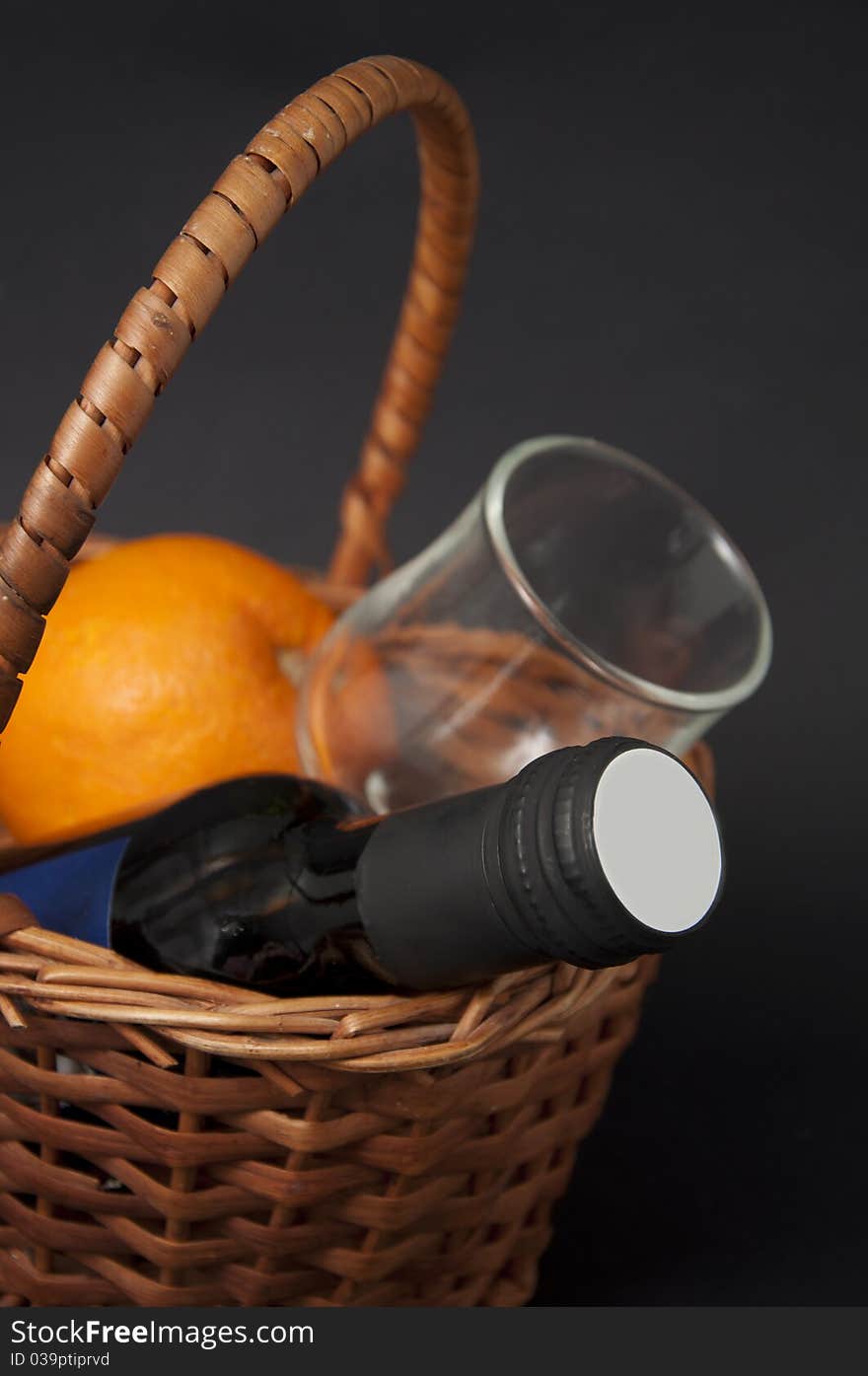 Wine and orange in the basket