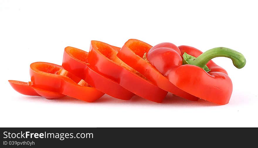 Red bell peppers are cut into slices and isolated.