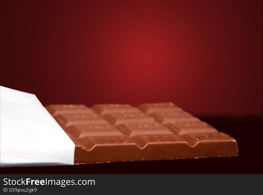 Chocolate in bar with open white cover