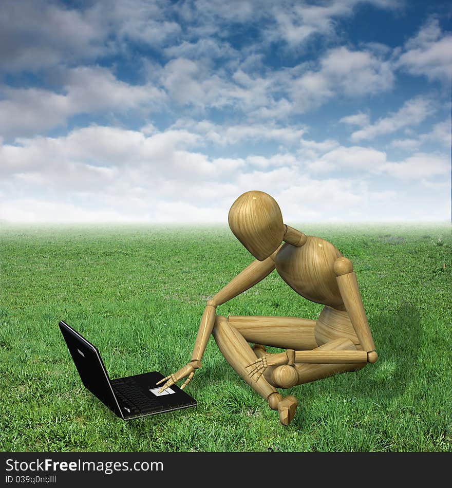 Very high resolution 3d rendering of a wooden mannequin working with his notebook sitting on the grass. Very high resolution 3d rendering of a wooden mannequin working with his notebook sitting on the grass