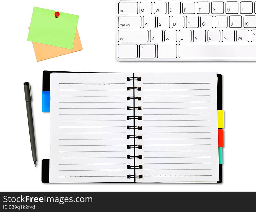 Open notepad and colored memo with a keyboard