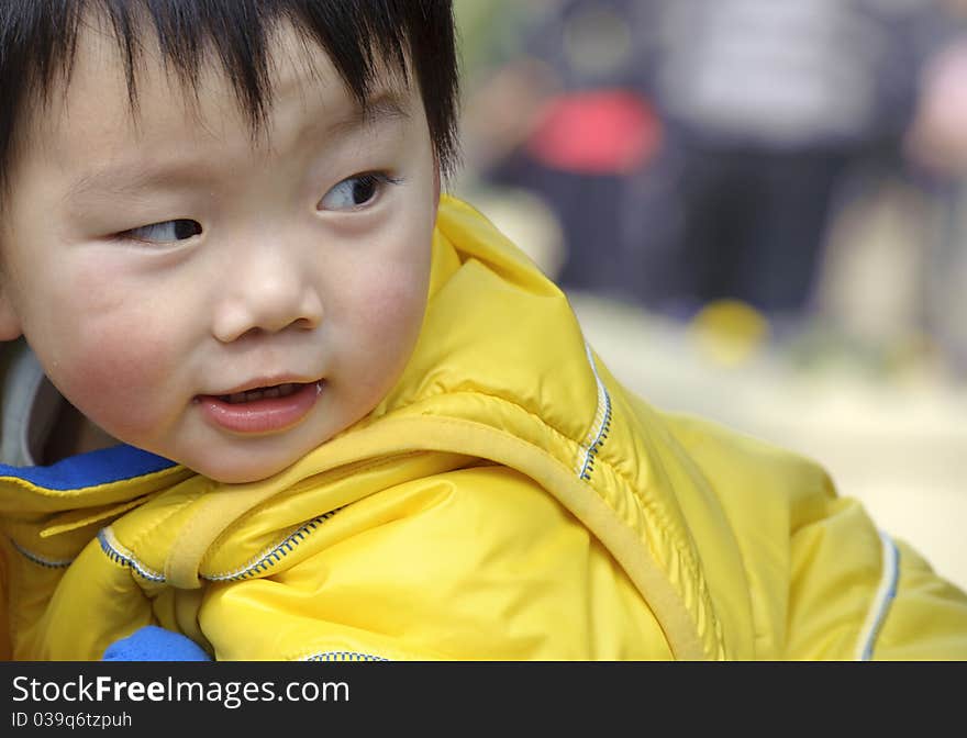 A happy baby is playing in a park. A happy baby is playing in a park