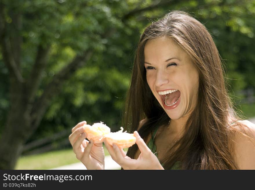 Excited Female Spliting Open Fresh Orange Fruit