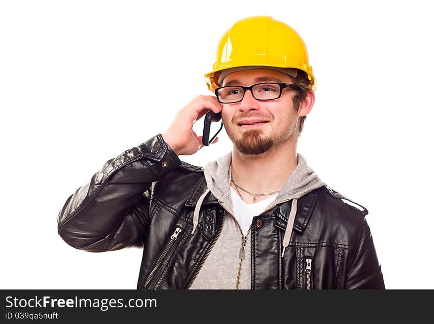 Handsome Young Man in Hard Hat Talking on Cell Phone Isolated on a White Background. Handsome Young Man in Hard Hat Talking on Cell Phone Isolated on a White Background.