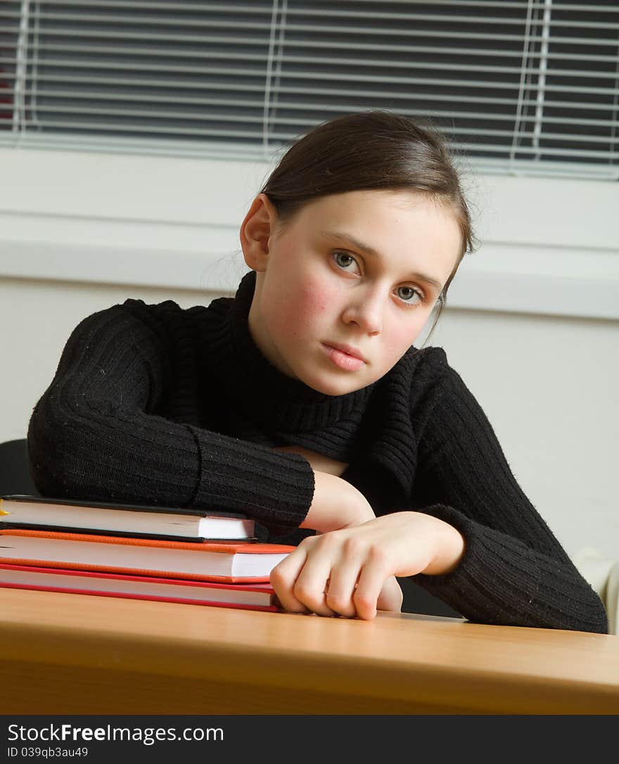 Young cute teen, seated at the table