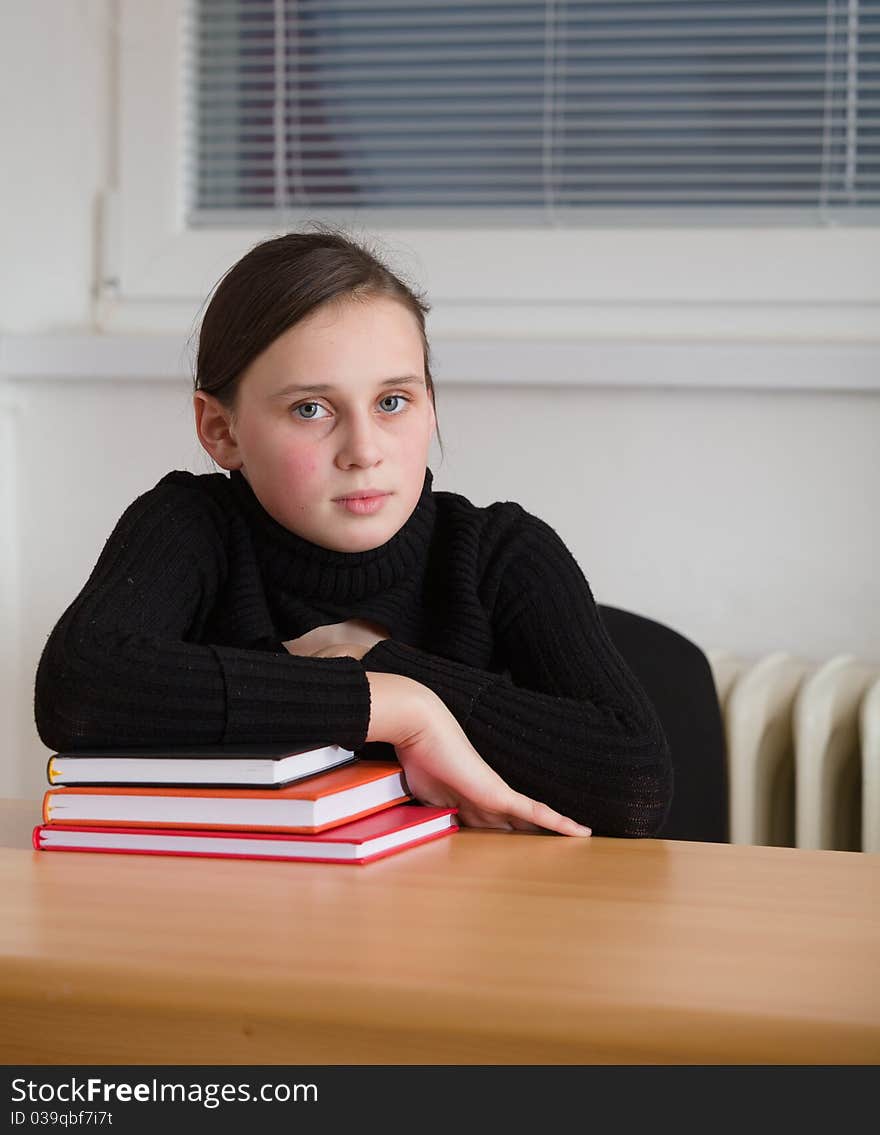 Young cute teen, seated at the table