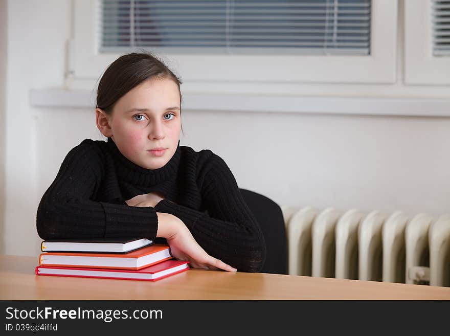 Young cute teen, seated at the table