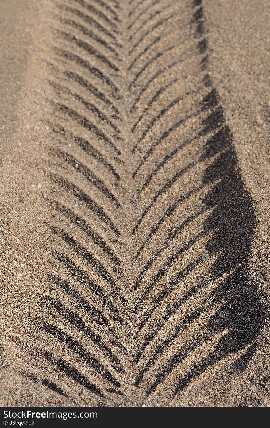 Vehicle impression in sand morning sun. Vehicle impression in sand morning sun