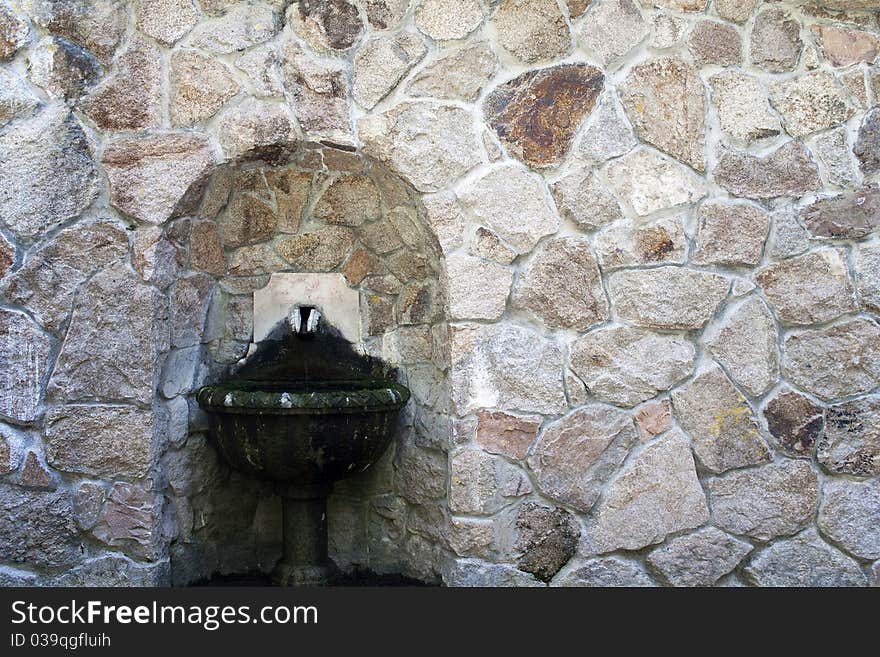 One old fountain in on stone wall