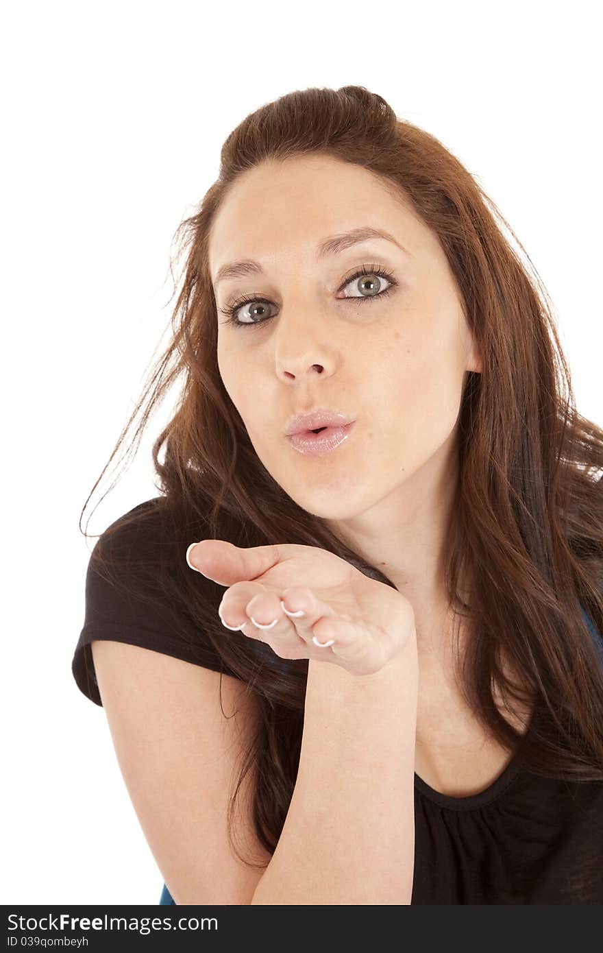 A brunette woman is blowing a big kiss. A brunette woman is blowing a big kiss.