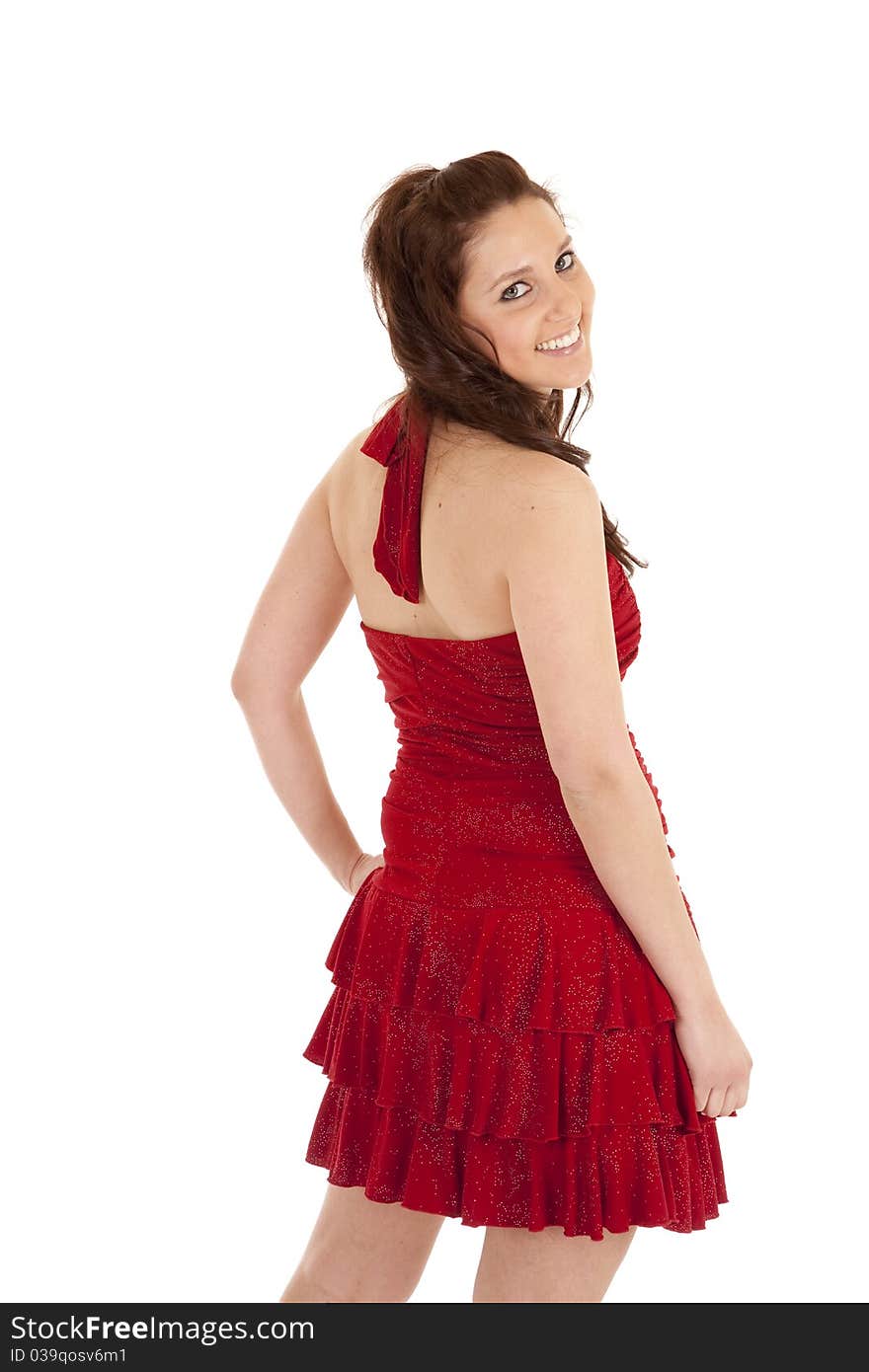 A woman in a red dress is looking back over her shoulder. A woman in a red dress is looking back over her shoulder.