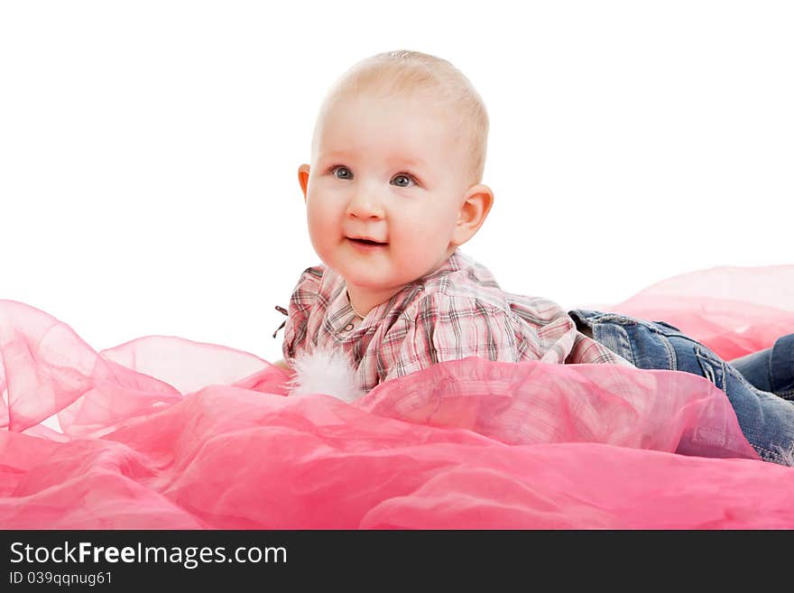 Portrait of the child which lies on a fabric in studio. Portrait of the child which lies on a fabric in studio