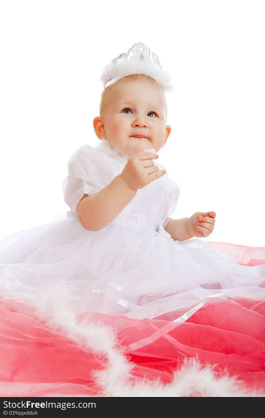 Portrait of the child sitting on a red fabric, isolated on a white background. Portrait of the child sitting on a red fabric, isolated on a white background