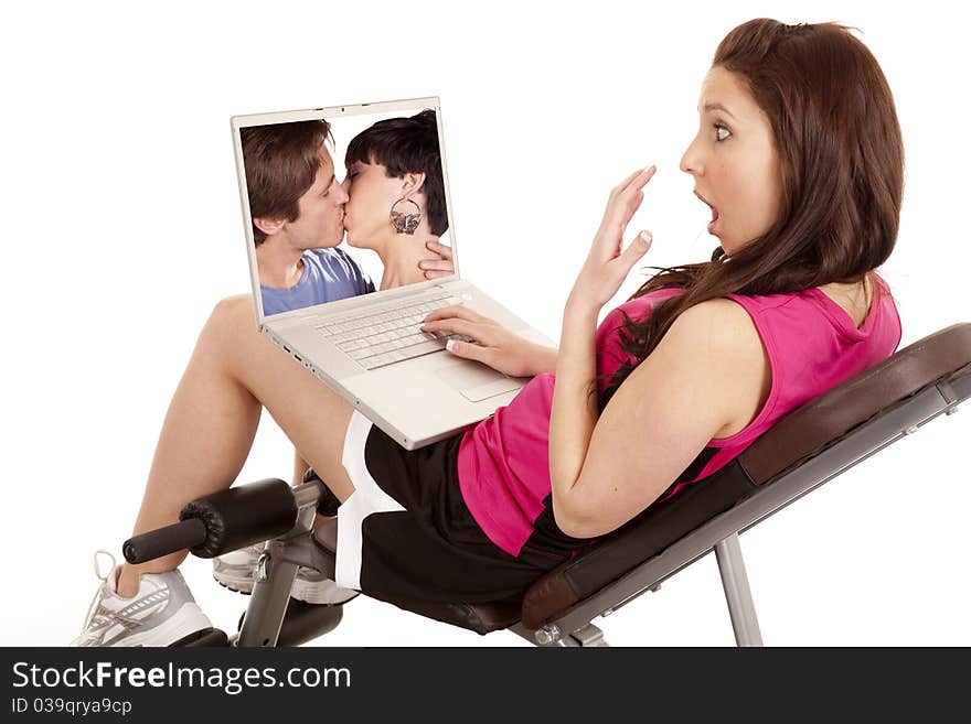 A woman is shocked at the couple kissing on her computer. A woman is shocked at the couple kissing on her computer.