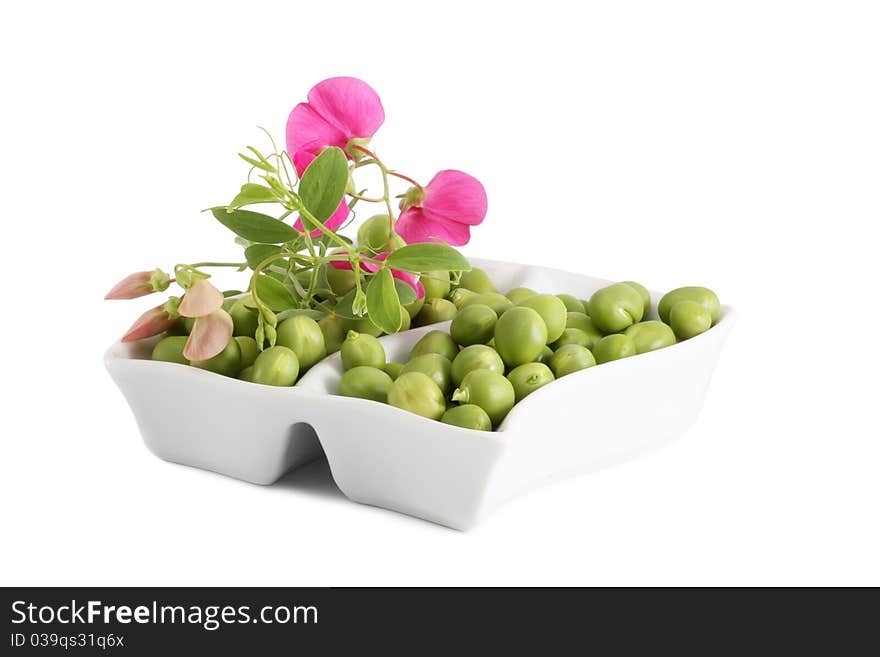 Green Peas and a branch with flowers on a white background