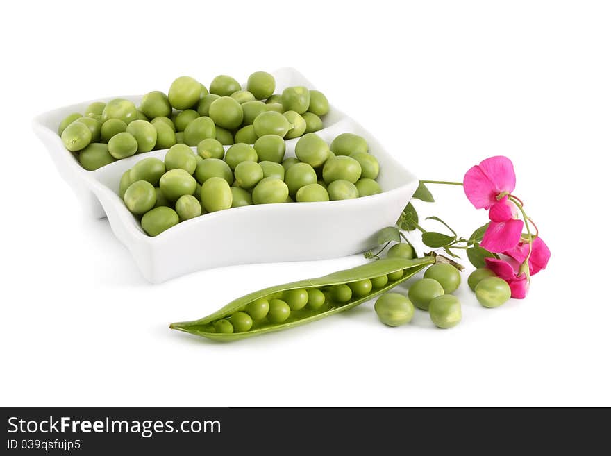 Green Peas and a branch with flowers on a white background