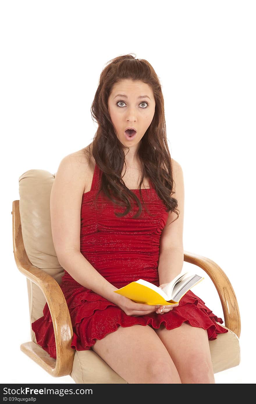 Woman red dress book sit shocked looking