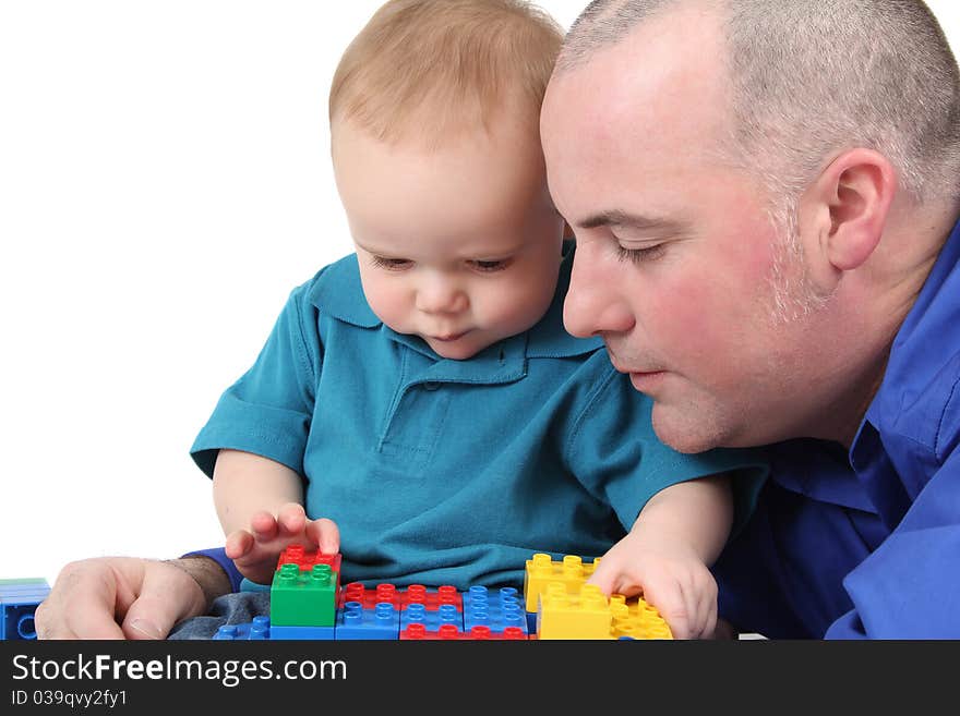 Father and son building with colorful blocks. Father and son building with colorful blocks