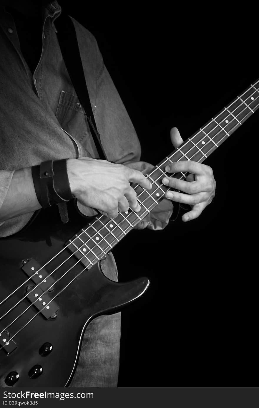 Electrical bass-guitar in male hands, black and white. Electrical bass-guitar in male hands, black and white