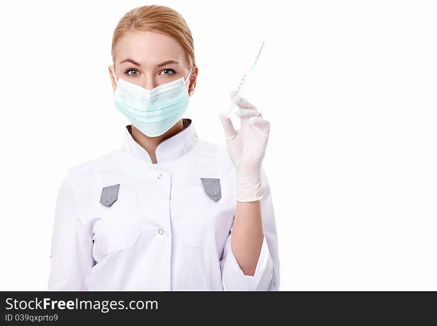 A young doctor with a syringe on white background. A young doctor with a syringe on white background