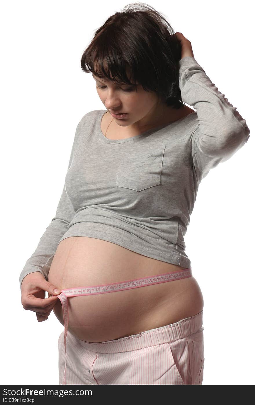 Pregnant young woman do measure her self. Pregnant young woman do measure her self