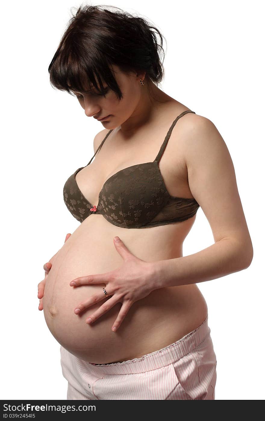 Pregnant woman in bra look to their stomach