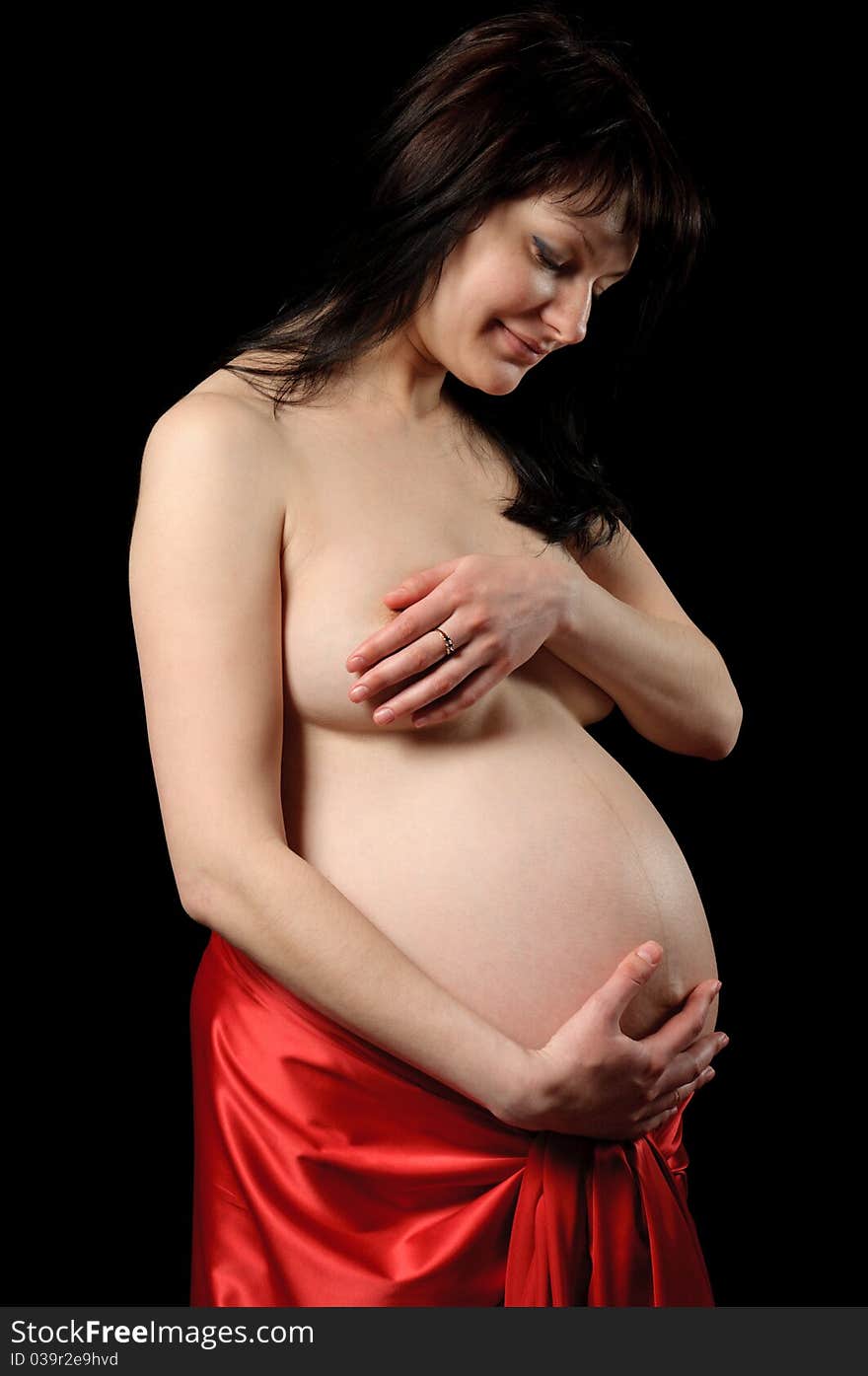 Pretty nude woman pregnancy with red fabric