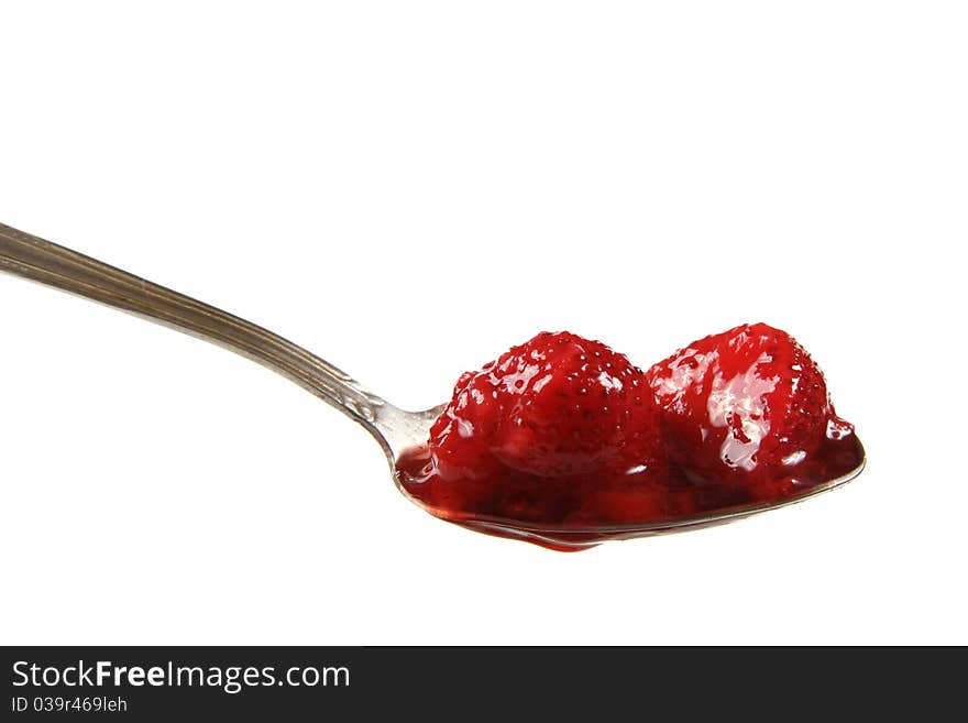 Defrosted strawberries on spoon isolated on white background