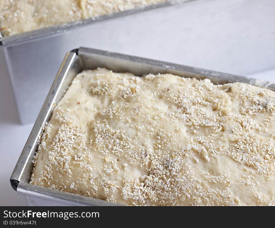 Unbaked olive bread loaf on white background