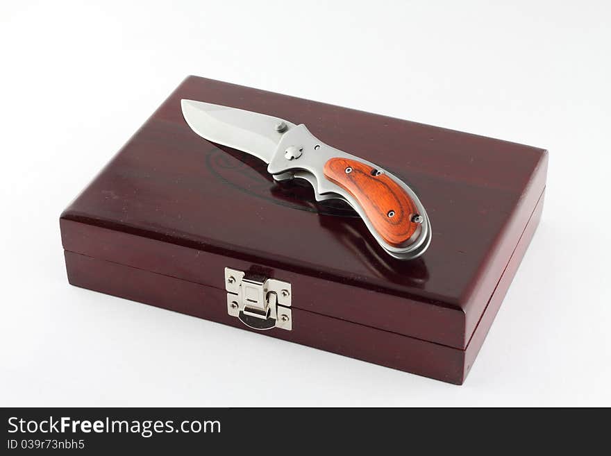 Knife on the wood box isolated on the white background. Knife on the wood box isolated on the white background.