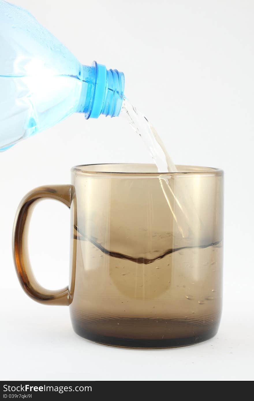 Pouring Water into Cup, isolated on the white background.