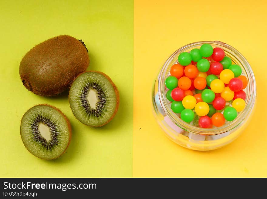 Contrast of kiwi fruit and candy. Contrast of kiwi fruit and candy