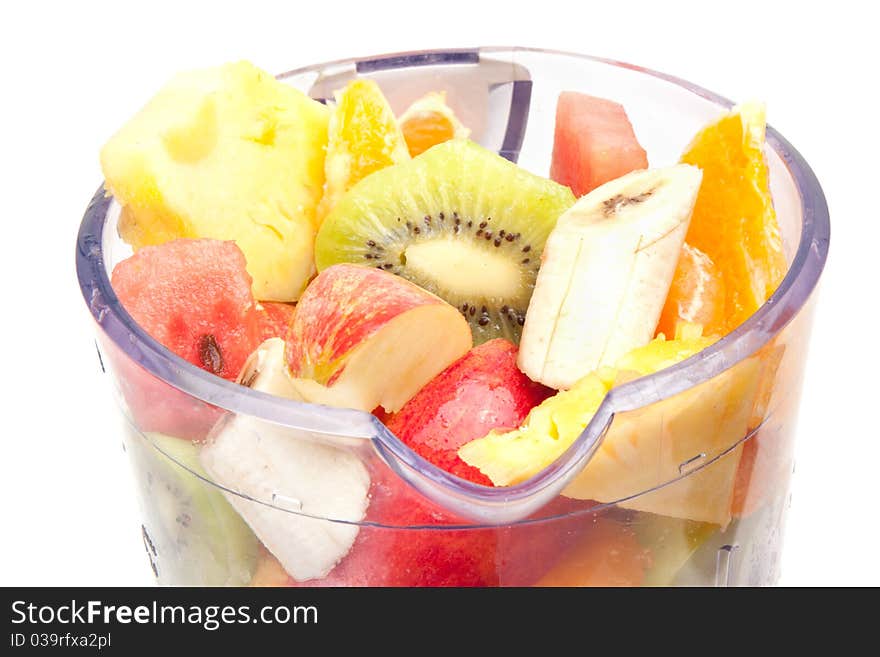 Mixed fruit in mixer with white background. Mixed fruit in mixer with white background