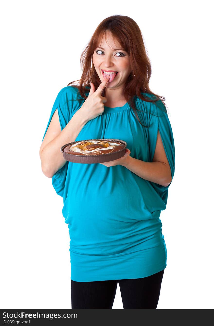 A smiling woman is tasting the cake