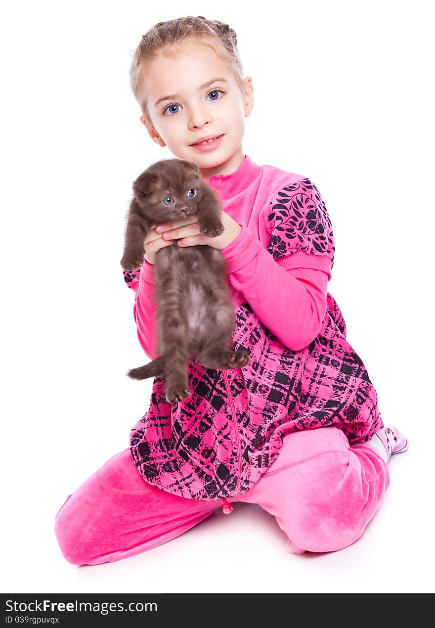 A smiling girl is playing with a kitten. isolated on a white background