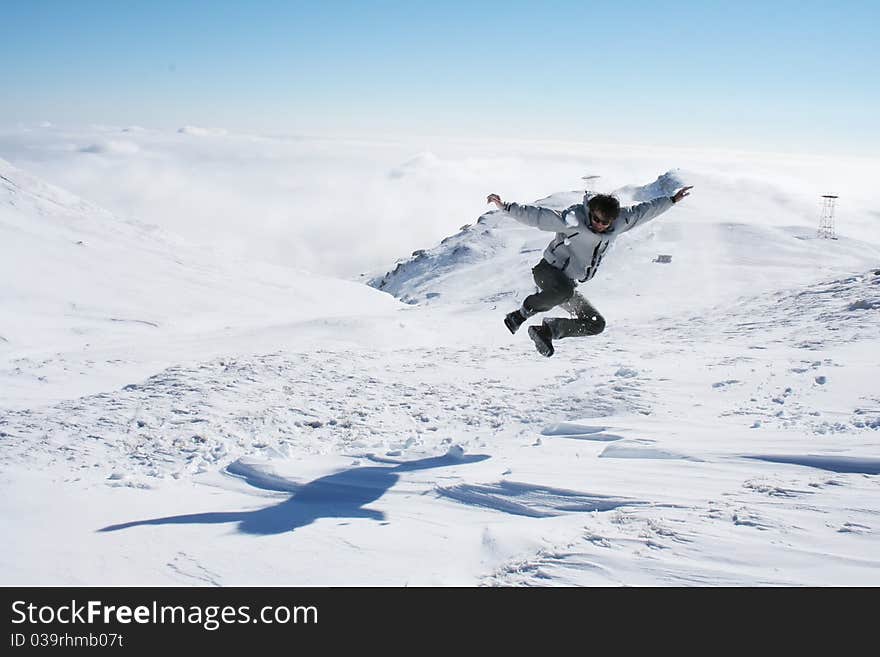 Young Man Jumping In The Snow For Fun