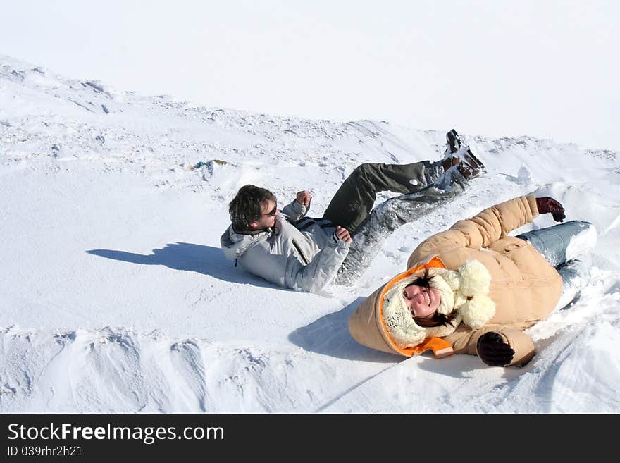 Young couple jumping in the snow