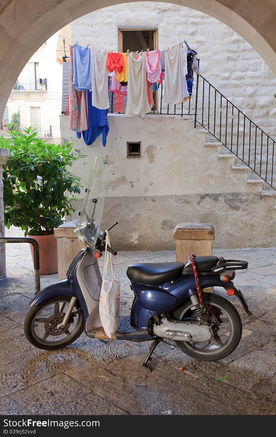 Retro blue scooter outside an Italian home. Retro blue scooter outside an Italian home