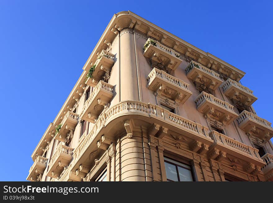 Traditional beige painted Italien apartments with ornate balconies. Traditional beige painted Italien apartments with ornate balconies