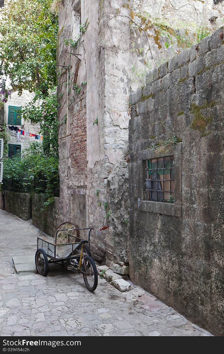 Abandoned delivery bike in old stone street