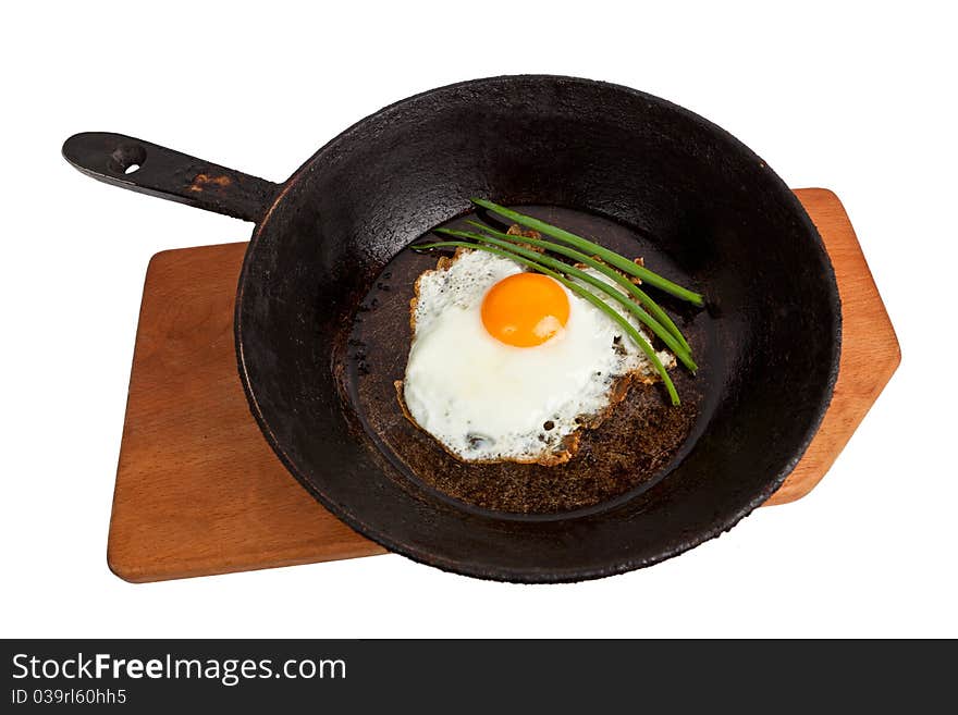 Fried Eggs On A Frying Pan On A Board