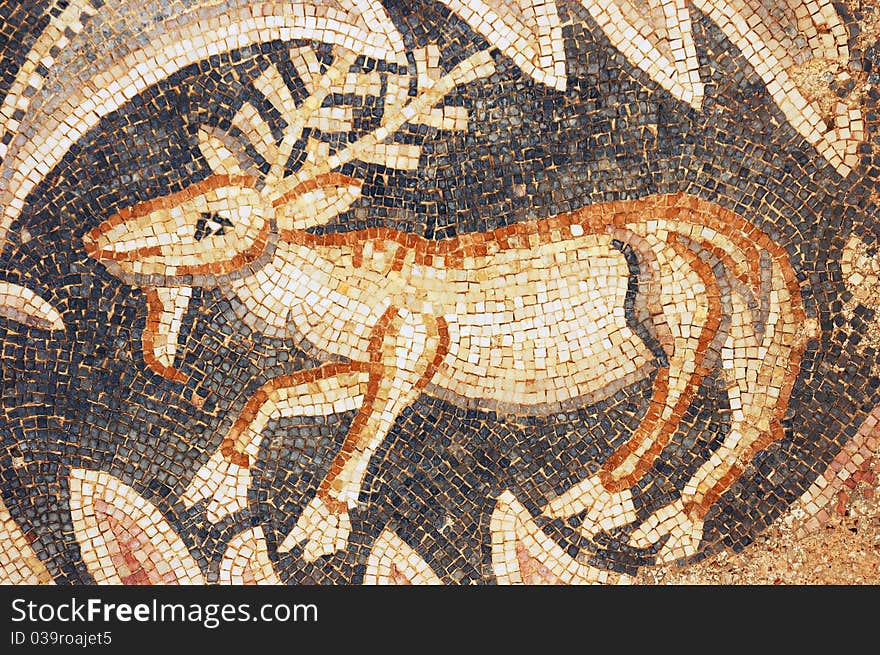 Close up of fragment of antique mosaic with a goat