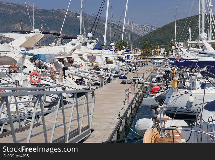 Boats at dock on a floating wooden jetty