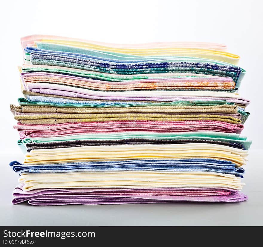 A stack of colored towels. isolated on a white background